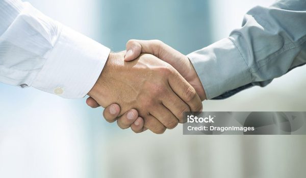 Close-up image of a firm handshake standing for a trusted partnership